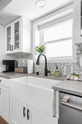 a white kitchen with a sink and a window at Hometown Hideaway - 4br25ba, Pool, Game Room in Greenwood