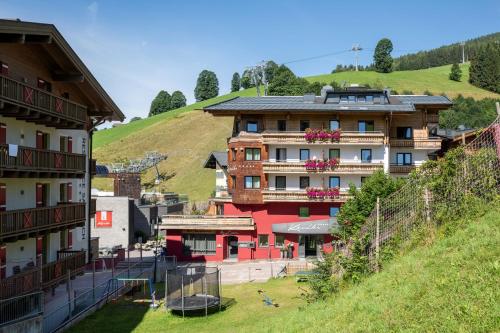 a building on the side of a hill at Hotel Kendler in Saalbach Hinterglemm