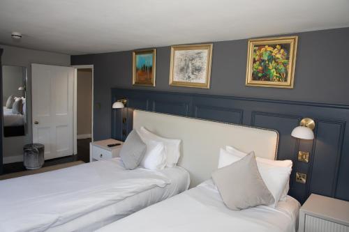 two beds in a room with blue walls at Henrietta House, a member of Radisson Individuals in Bath