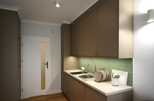 a kitchen with brown cabinets and a sink at Port Rewa in Rewa