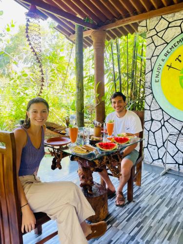 a man and a woman sitting at a table at Treetops ella in Ella