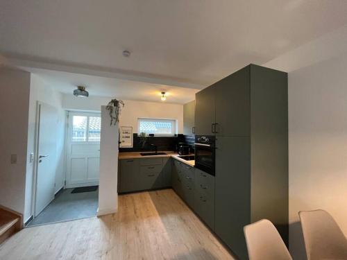 a kitchen with gray cabinets and a counter top at Fischer-Chic - Die Bude Maasholm in Maasholm