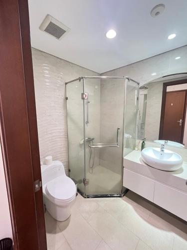 a bathroom with a shower and a toilet and a sink at Park 12 Homestay in Hanoi