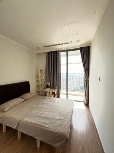 a bedroom with a bed and a large window at Park 12 Homestay in Hanoi