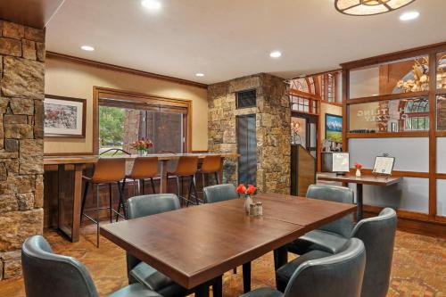 a restaurant with a table and chairs and a bar at Wyoming Inn of Jackson Hole in Jackson