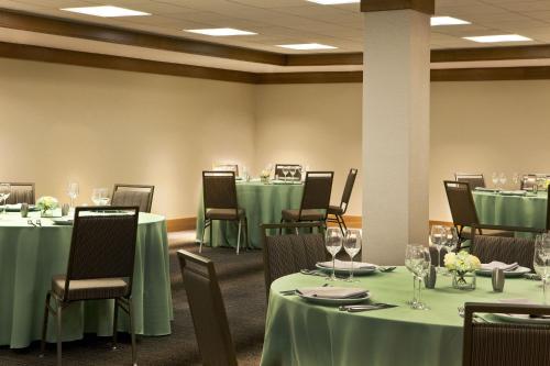 a banquet room with tables and chairs with green tablecloths at The Westin Portland Harborview in Portland