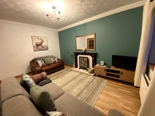 a living room with a couch and a fireplace at Eileen's Cottage in Castlerock