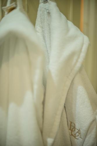 a white robe is hanging on a wall at Buccleuch and Queensberry Arms Hotel in Thornhill