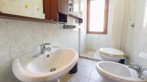 a bathroom with a sink and a toilet at Sardinianworld - Frontemare Apartment-Funtana Meiga in Funtana Meiga