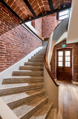 a staircase with a brick wall and a door at Ecole St. Pierre Hotel in Istanbul