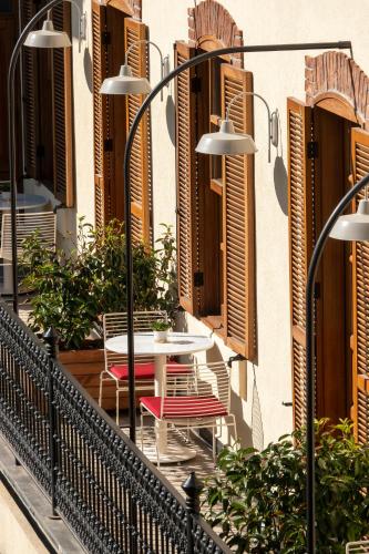 a table and chairs on the balcony of a building at Ecole St. Pierre Hotel in Istanbul