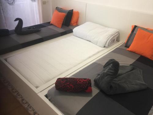 a room with two beds and a black and white floor at Edificio Comodoro in Los Cristianos