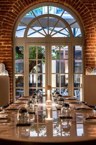 a long table with wine glasses in front of a window at Ecole St. Pierre Hotel in Istanbul