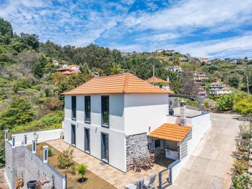 a white house with an orange roof at Eira in Camacha
