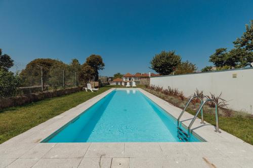 a swimming pool in the backyard of a house at Home With a Pool by Vacationy in Porto