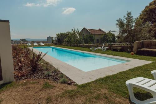 a swimming pool in the backyard of a house at Home With a Pool by Vacationy in Porto
