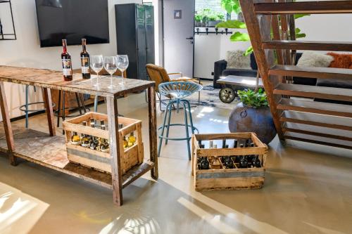 a room with wine glasses and a table with wine bottles at Art Apartmens Kyjov in Kyjov