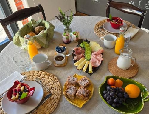 a table topped with plates of food and fruit at Art Garage Varese in Biandronno