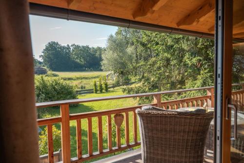 a balcony with a view of a field and trees at Bayern Chalets bei Salzburg und Berchtesgaden mit Whirlpool und Sauna in Ainring