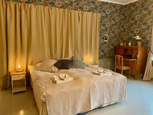 a bedroom with a bed with two animals laying on it at Pensionat Kanalvillan in Väddö
