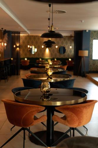 a row of tables and chairs in a restaurant at The James Rotterdam in Rotterdam