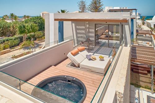 a balcony with a swimming pool on a house at Paralos Kosta Alímia in Hersonissos