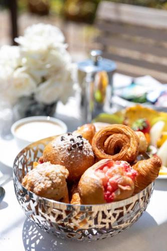 a bowl of pastries and onion rings on a table at Coquillade Provence - Relais & Châteaux in Gargas