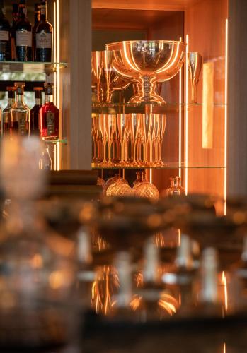 a bar with wine glasses on a shelf at Coquillade Provence - Relais & Châteaux in Gargas