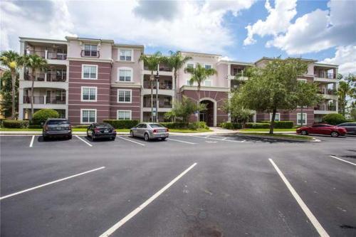 a parking lot with cars parked in front of a building at The Epic Boca Penthouse Vista Cay Orlando in Orlando