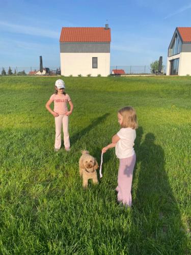 two young girls playing with a teddy bear in a field at Rybical 42 in Rybical