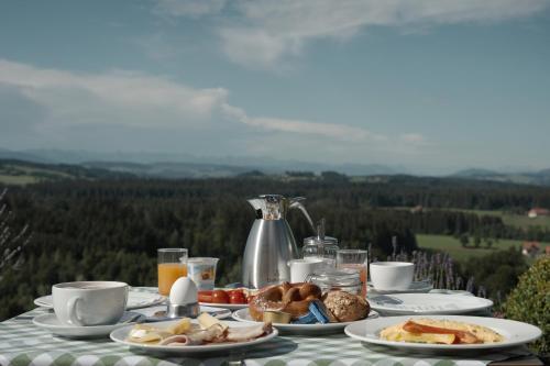 a table with plates of food and coffee on it at Berghotel Jägerhof ****S in Isny im Allgäu