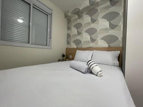 a bedroom with a large white bed and a window at FOR Consolação in Sao Paulo