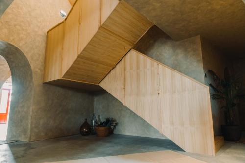 a staircase in a room with a wooden wall at The Farm - Azores Boutique House in Ponta Delgada