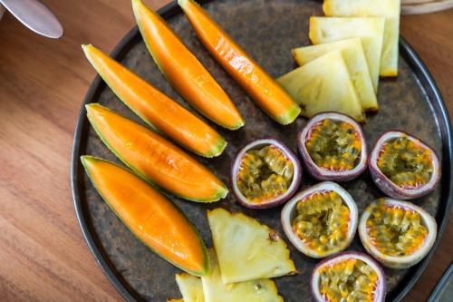 a plate of vegetables and fruit on a table at The Farm - Azores Boutique House in Ponta Delgada