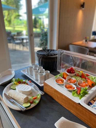 a buffet with two plates of food on a table at Boutiquehotel Drei Ringe Schwörstadt - Rheinfelden in Schwörstadt
