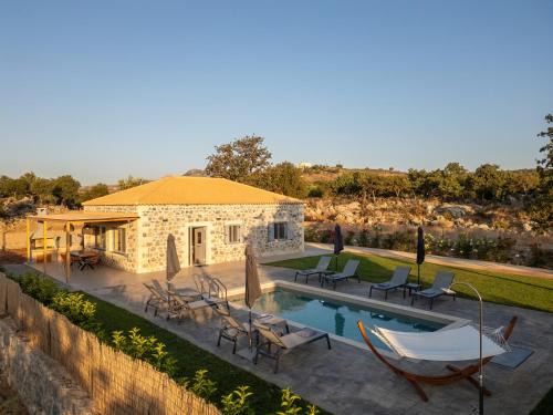 a villa with a swimming pool and a house at Miroy Mountain View Villa in Prinés
