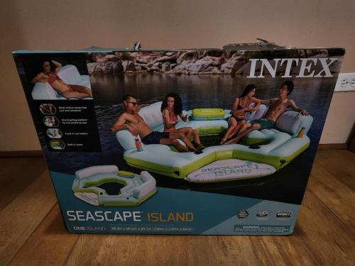 a box of an escape island water slide at Oceanfront Dock of the Bay Retreat in Scotts Hill