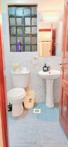 a bathroom with a toilet and a sink at Golden Touch Luxury Superior in Nairobi