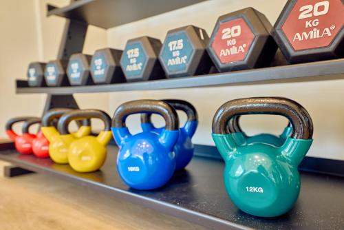a row of dumbbells on a shelf in a store at Paralos Kosta Alímia in Hersonissos