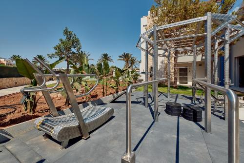 aption to a park with a bench and rails at Paralos Kosta Alímia in Hersonissos
