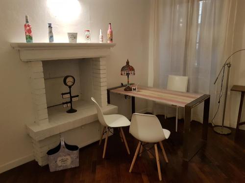 a living room with a table and a fireplace at Allegra Toscana - Affittacamere Guest house Arezzo in Arezzo