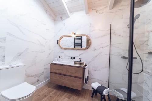 a bathroom with a sink and a mirror at La Casa del Jardín in Candeleda