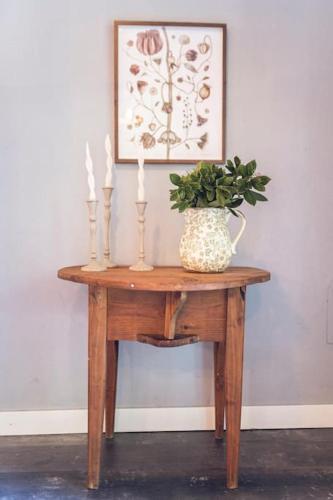 a table with a vase on it with a plant on it at La Casa del Jardín in Candeleda