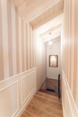 an empty hallway with striped walls and wood floors at La Casa del Jardín in Candeleda