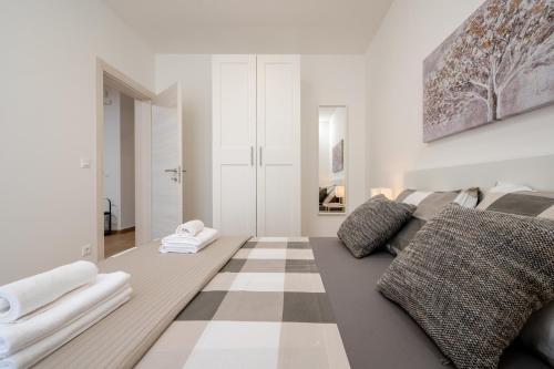 a living room with a couch and a checkered floor at Apartment SarAna Trogir in Trogir