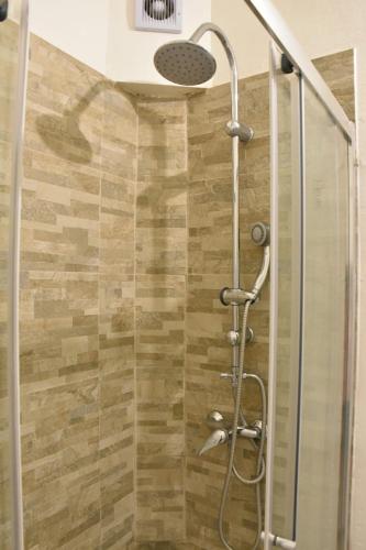 a shower with a glass door and a shower head at Allegra Toscana - Affittacamere Guest house Arezzo in Arezzo