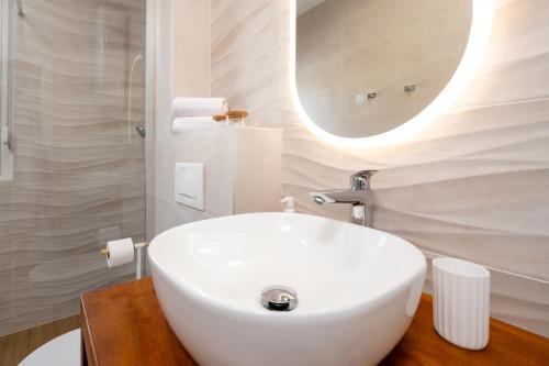 a bathroom with a white sink and a mirror at Apartment SarAna Trogir in Trogir