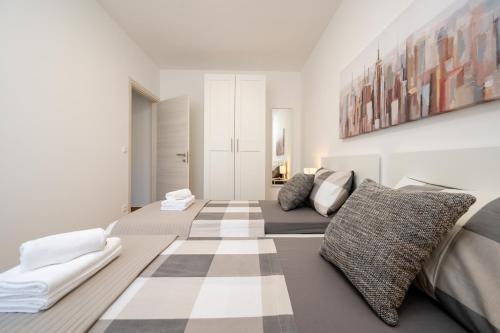 a living room with two beds and a checkered floor at Apartment SarAna Trogir in Trogir