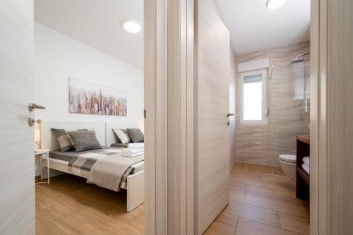 a bedroom with a bed and a toilet at Apartment SarAna Trogir in Trogir