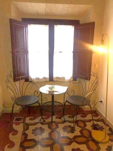 a room with a table and two chairs and a window at Allegra Toscana - Affittacamere Guest house Arezzo in Arezzo